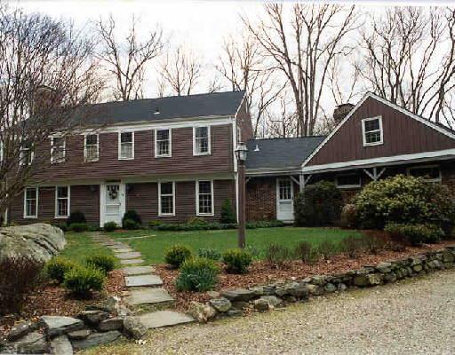 115 Whipstick Road Wilton, CT 06897 - Photo 1 of 1 a front view of a house with garden