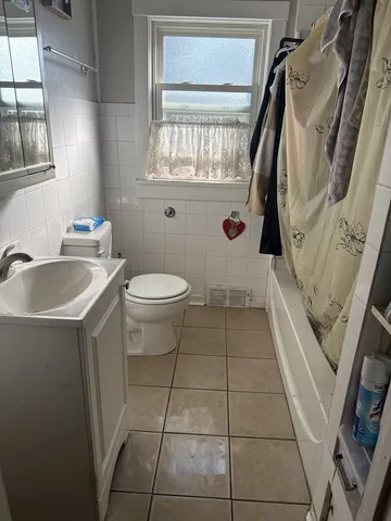 a bathroom with a sink mirror and toilet