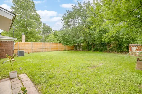 a view of a swimming pool with a yard