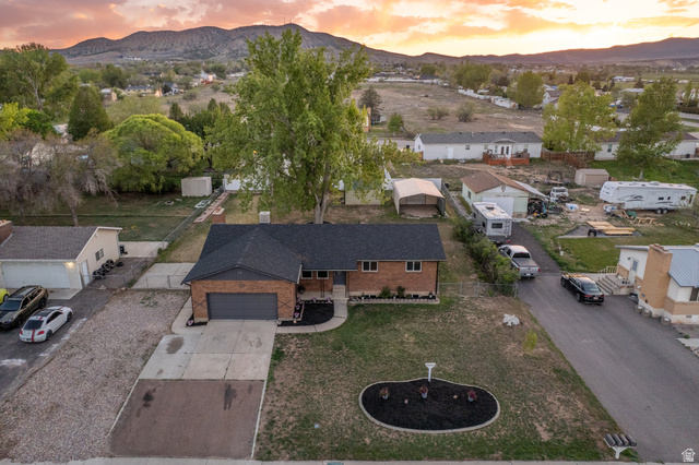 634 South 2100th Street West Vernal, UT 84078 - Photo 63 of 71 Brick-front residence featuring a dark shingle roof and an attached garage