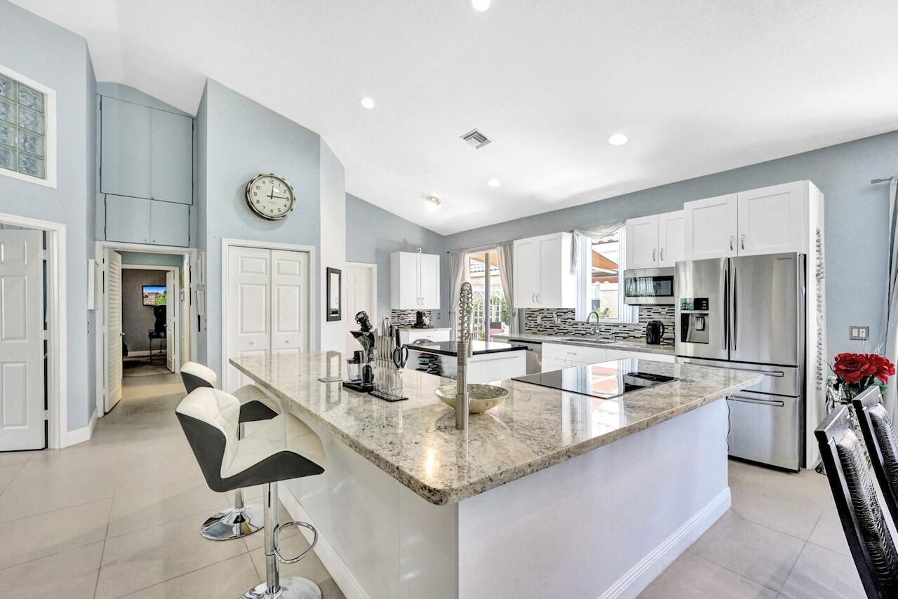 11067 Springbrook Circle Boynton Beach, FL 33437 - Photo 11 of 50 a kitchen with granite countertop a sink and cabinets
