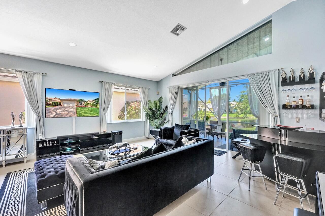 11067 Springbrook Circle Boynton Beach, FL 33437 - Photo 16 of 50 a living room with furniture and a flat screen tv
