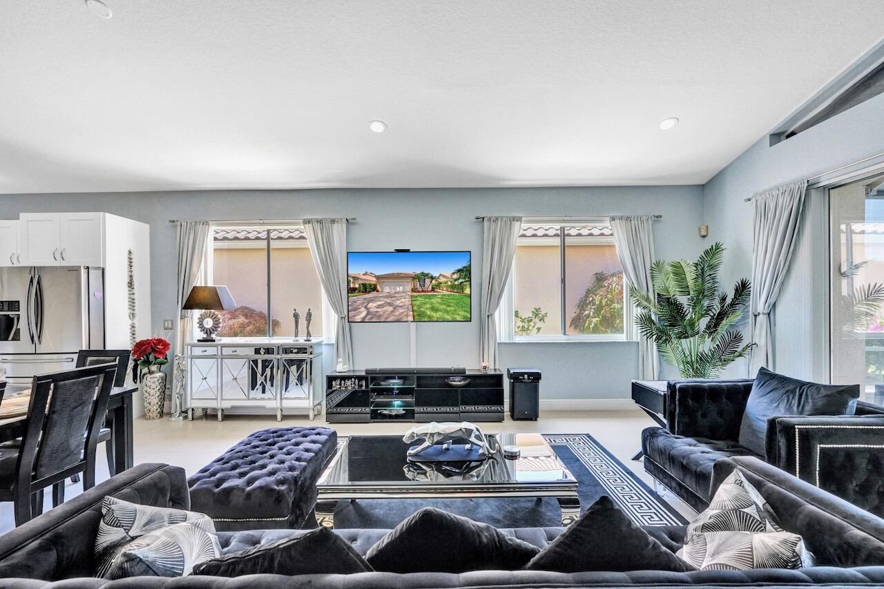 11067 Springbrook Circle Boynton Beach, FL 33437 - Photo 20 of 50 a living room with furniture and a flat screen tv