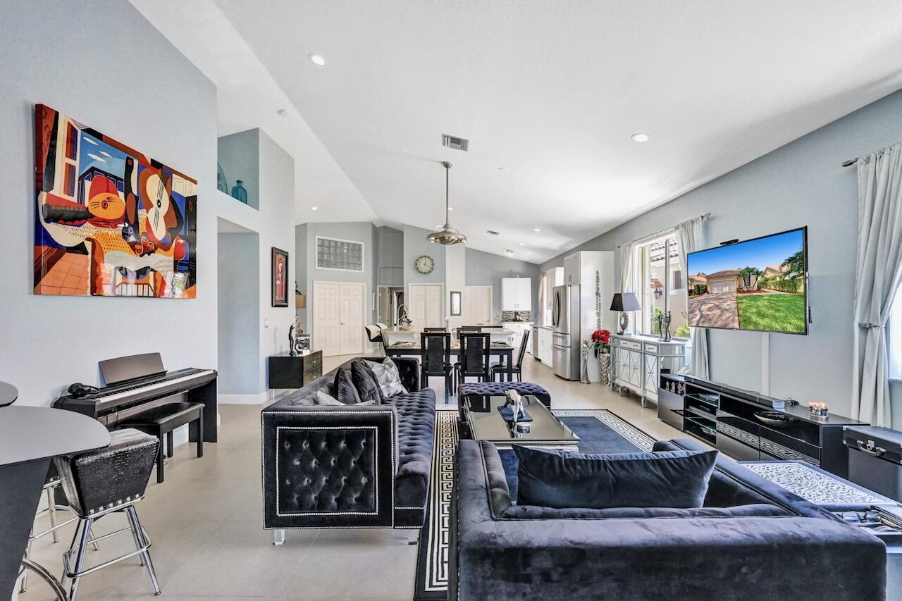 11067 Springbrook Circle Boynton Beach, FL 33437 - Photo 21 of 50 a living room with furniture and a flat screen tv