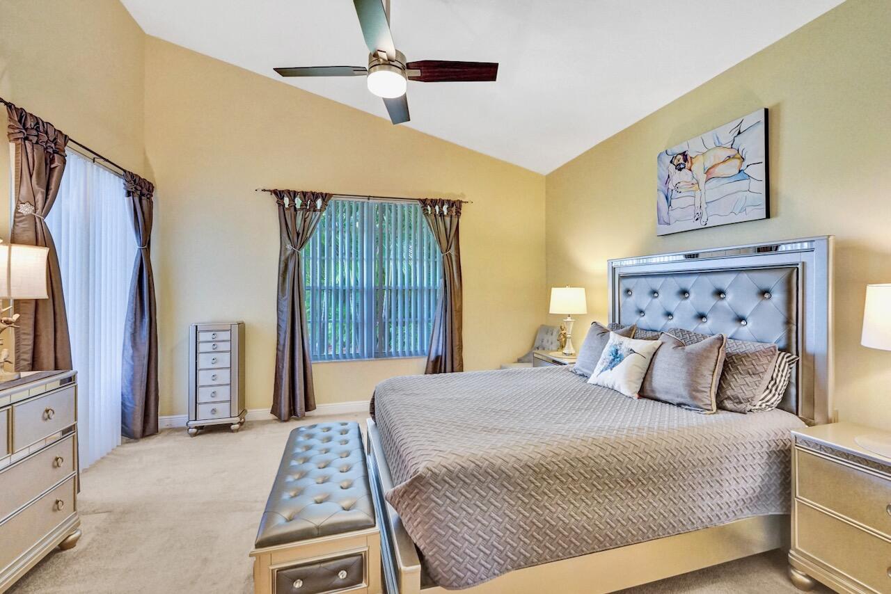 11067 Springbrook Circle Boynton Beach, FL 33437 - Photo 23 of 50 a bedroom with a bed and a walk in closet