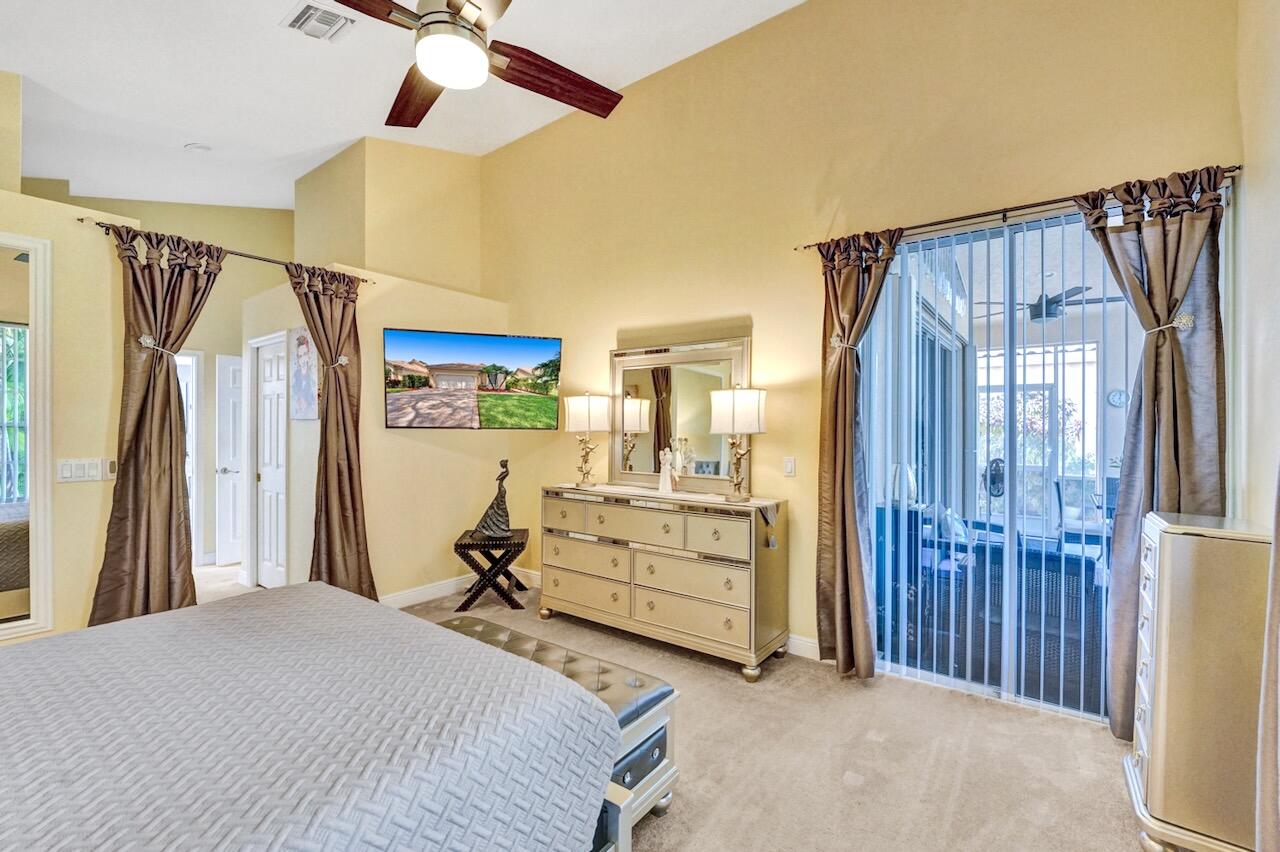 11067 Springbrook Circle Boynton Beach, FL 33437 - Photo 25 of 50 a bedroom with a bed and a chandelier
