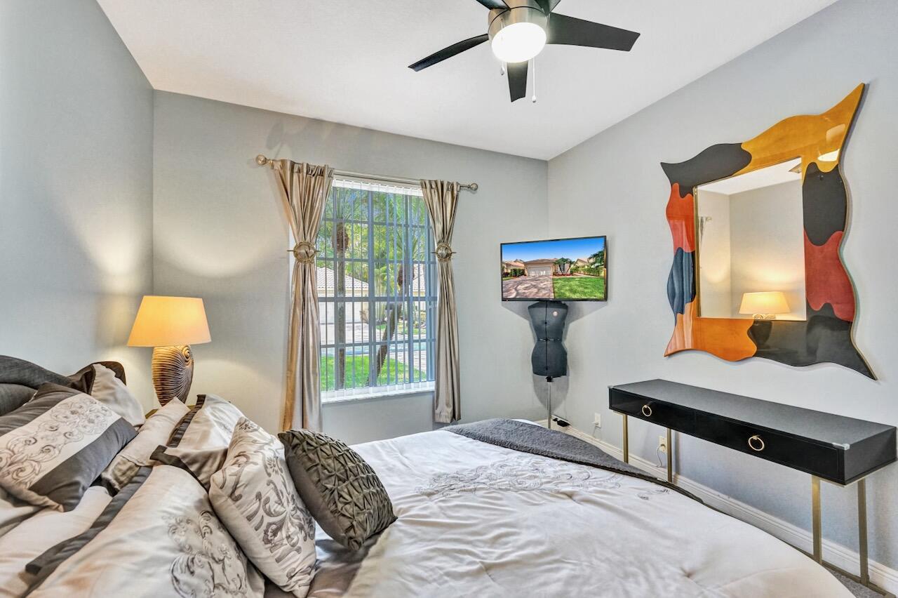 11067 Springbrook Circle Boynton Beach, FL 33437 - Photo 31 of 50 a bedroom with a bed and wooden floor