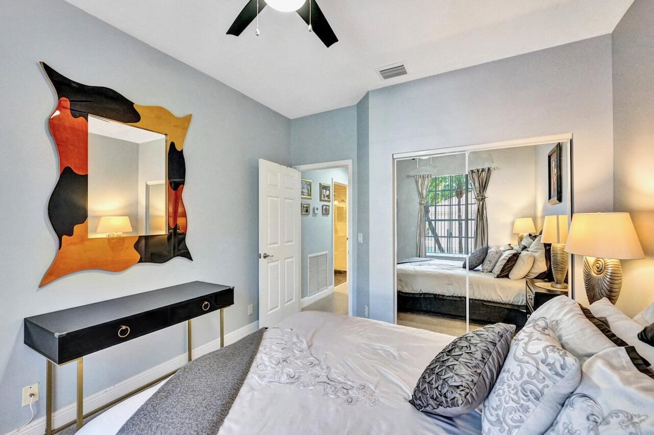 11067 Springbrook Circle Boynton Beach, FL 33437 - Photo 32 of 50 a bedroom with a bed and wooden floor