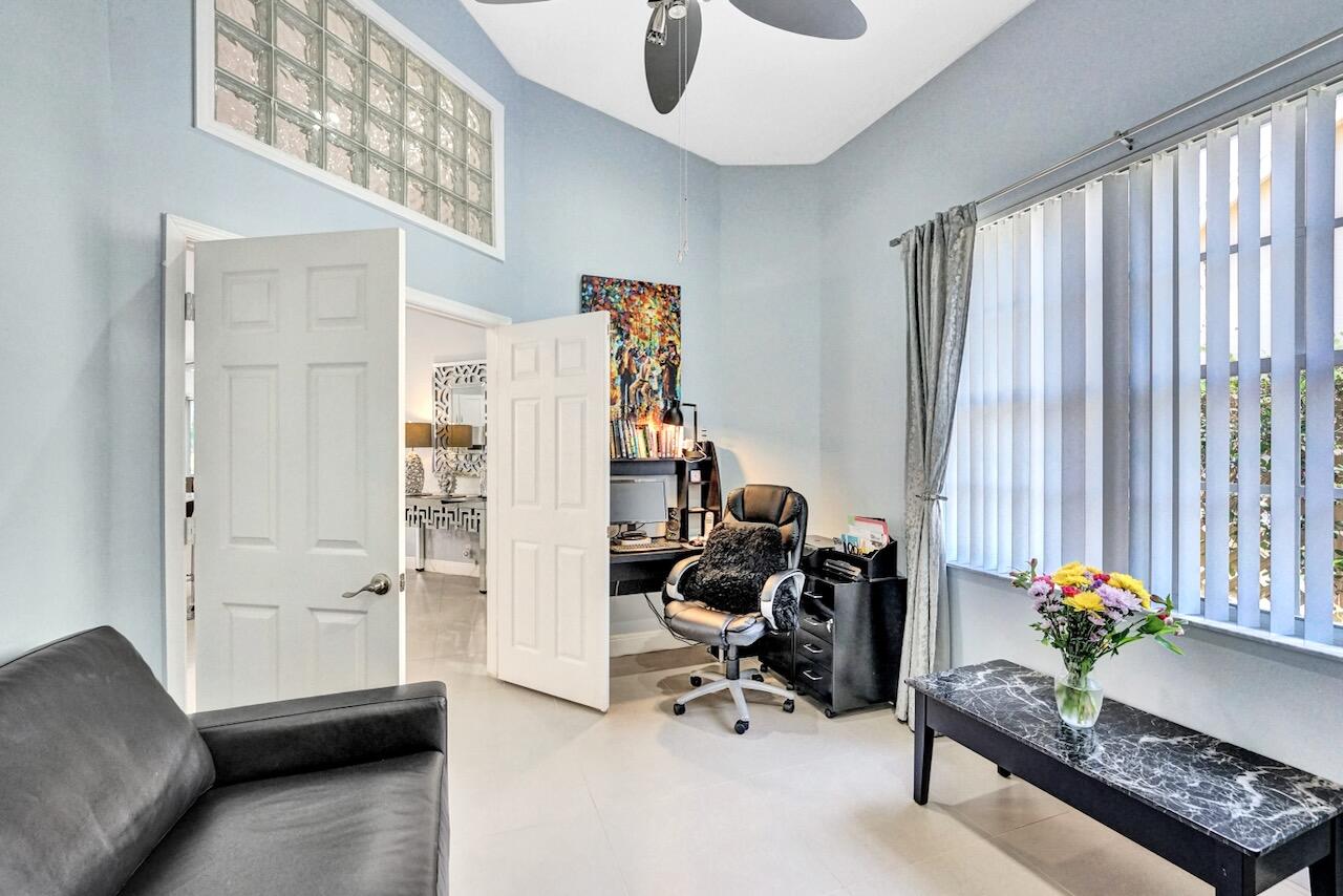 11067 Springbrook Circle Boynton Beach, FL 33437 - Photo 33 of 50 a livingroom with workspace and a couch