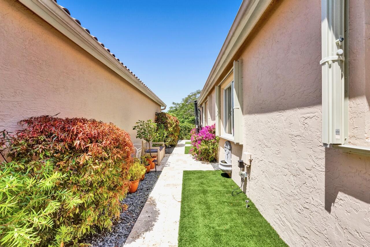 11067 Springbrook Circle Boynton Beach, FL 33437 - Photo 47 of 50 a view of a pathway of a house with a yard