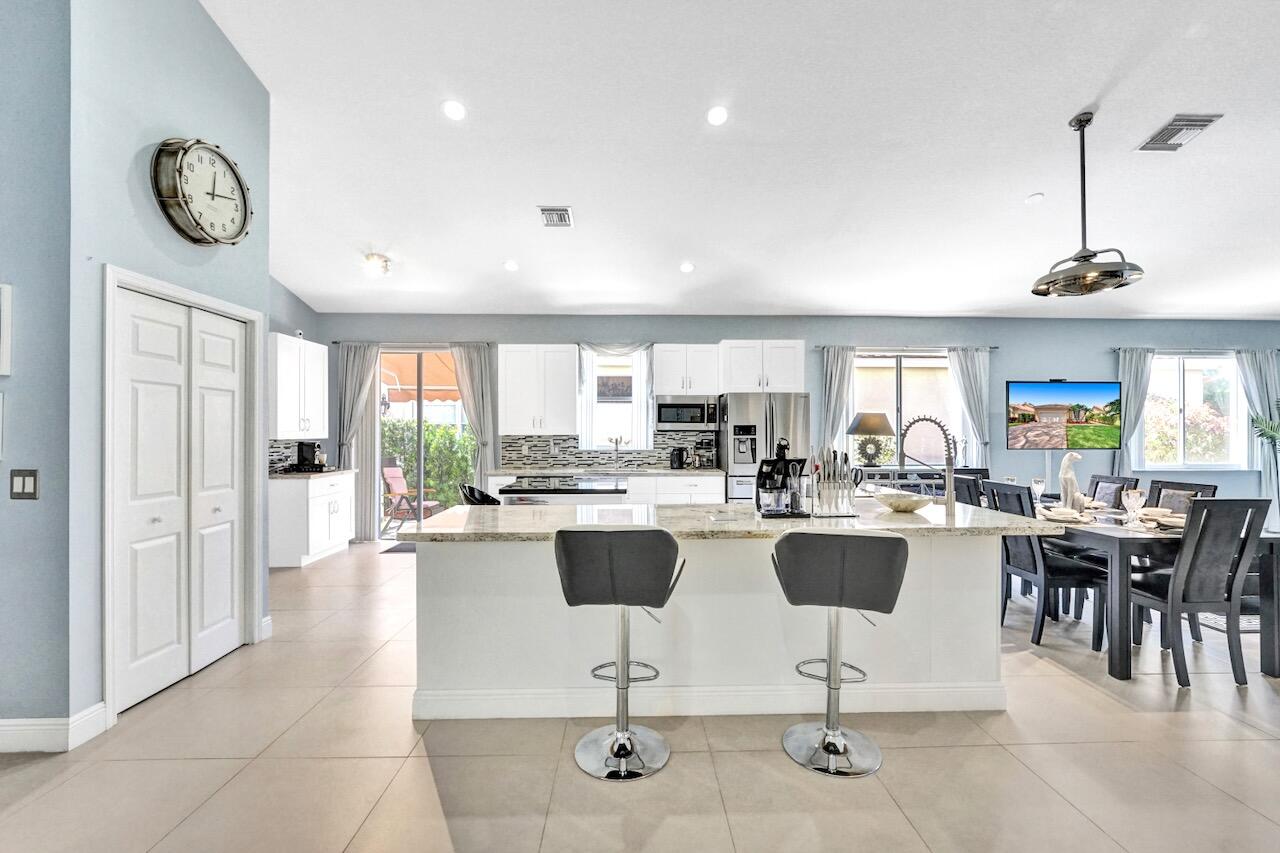 11067 Springbrook Circle Boynton Beach, FL 33437 - Photo 5 of 50 a view of a dining room with furniture window and wooden floor