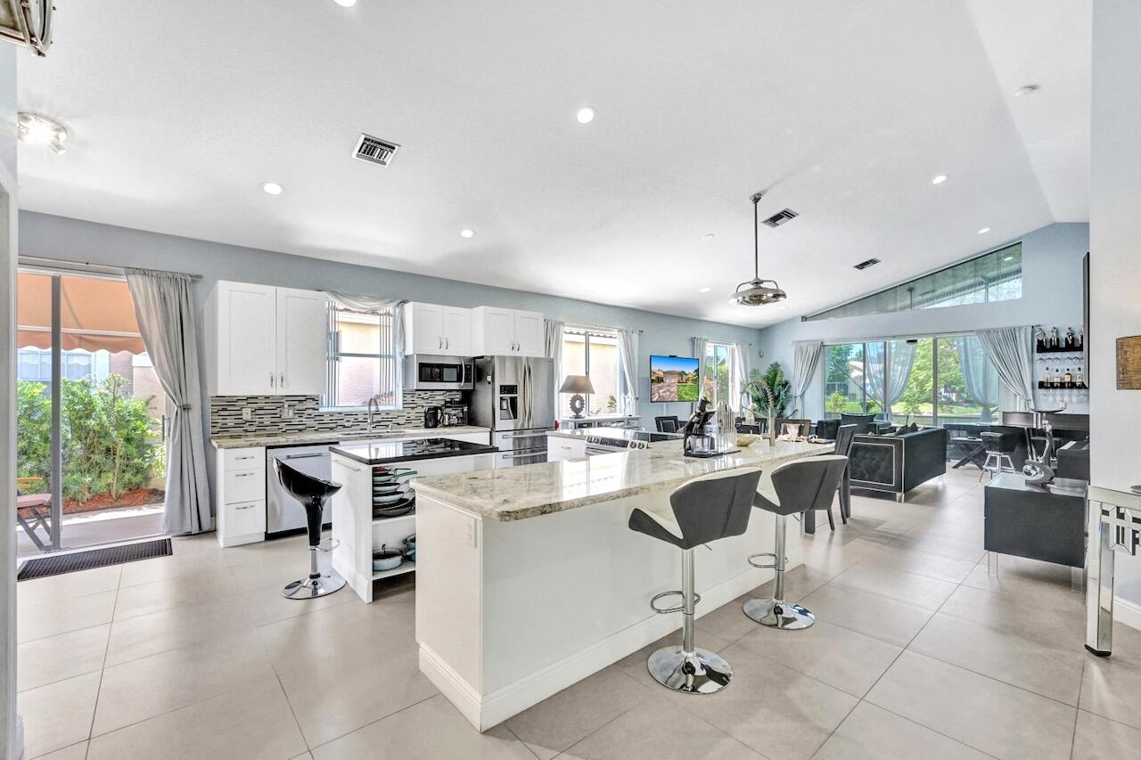11067 Springbrook Circle Boynton Beach, FL 33437 - Photo 6 of 50 a large kitchen with a table and chairs
