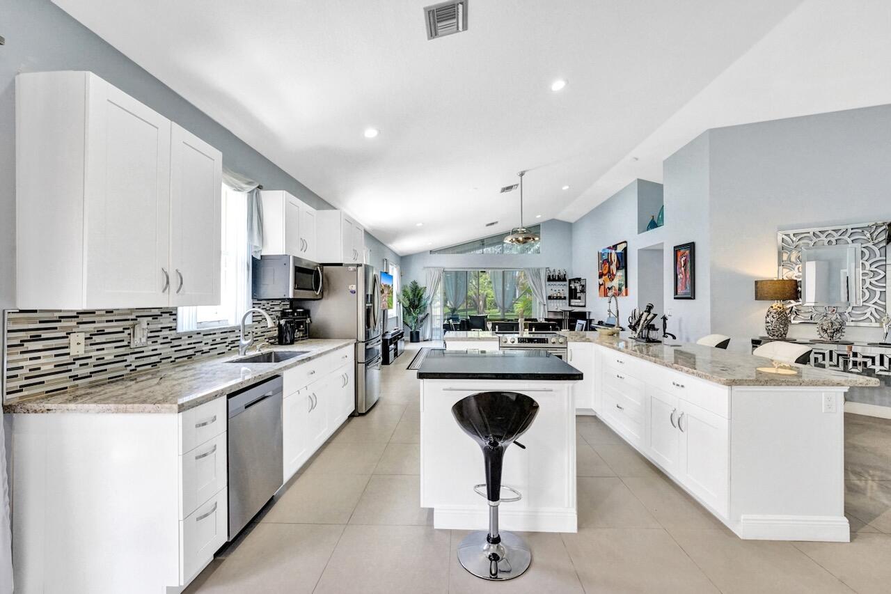 11067 Springbrook Circle Boynton Beach, FL 33437 - Photo 7 of 50 a kitchen with sink stove and cabinets