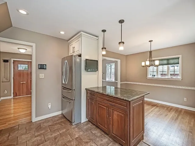 a kitchen with stainless steel appliances granite countertop a refrigerator and a sink