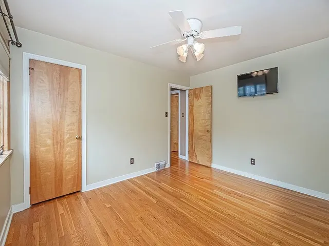 wooden floor in an empty room with a window