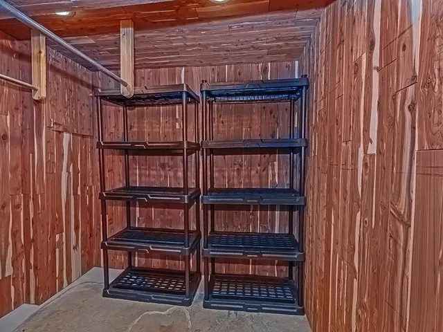 a view of empty room with wooden floor and fireplace