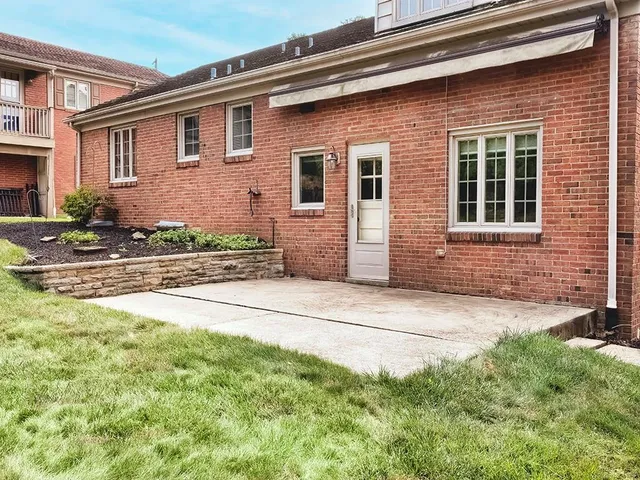a front view of a house with a garden and yard