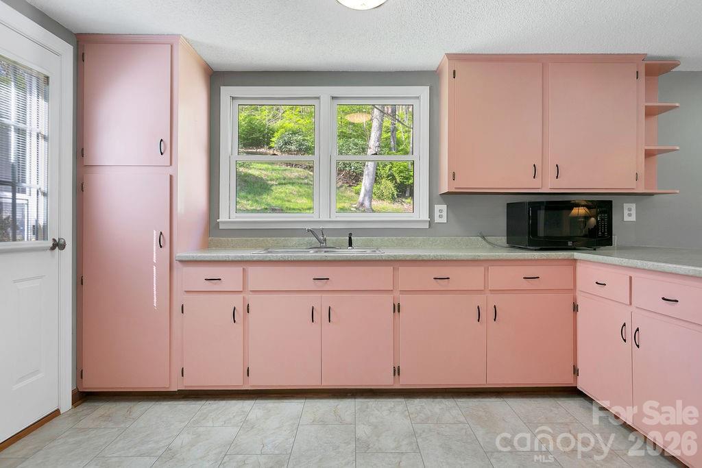 1482 Island Ford Road Brevard, NC 28712 - Photo 15 of 48 a kitchen with granite countertop cabinets and window