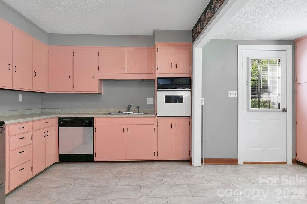 1482 Island Ford Road Brevard, NC 28712 - Photo 16 of 48 a kitchen with granite countertop cabinets and white appliances