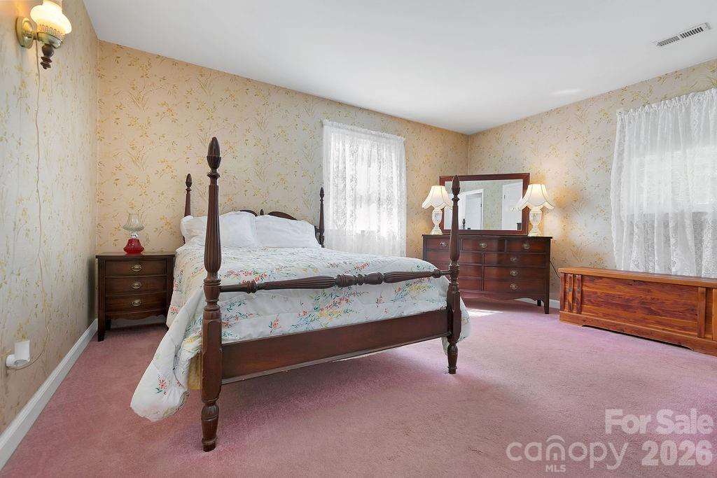 1482 Island Ford Road Brevard, NC 28712 - Photo 20 of 48 a bedroom with a bed and a table in it
