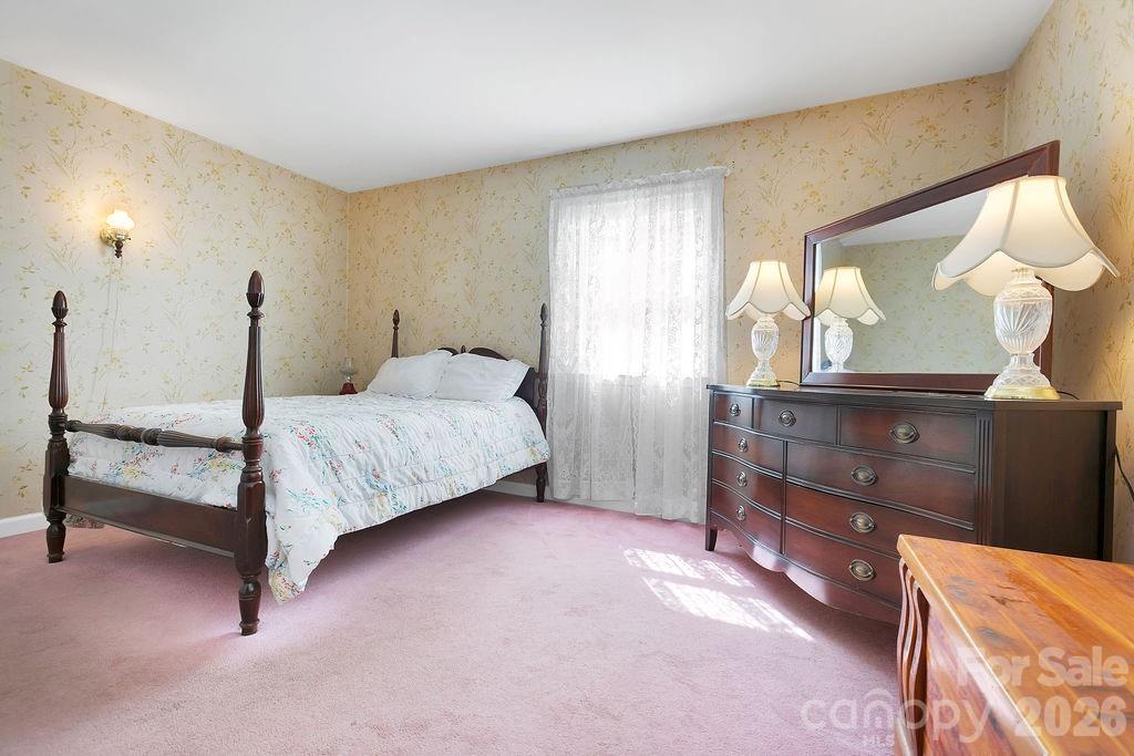 1482 Island Ford Road Brevard, NC 28712 - Photo 21 of 48 a bedroom with a bed and a dresser