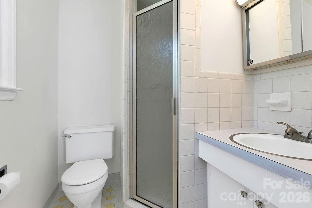 1482 Island Ford Road Brevard, NC 28712 - Photo 23 of 48 a bathroom with a granite countertop toilet sink and mirror
