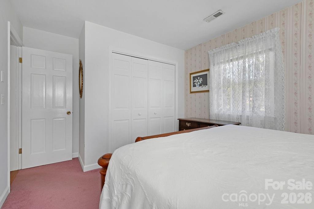 1482 Island Ford Road Brevard, NC 28712 - Photo 25 of 48 a bedroom with a bed and a window