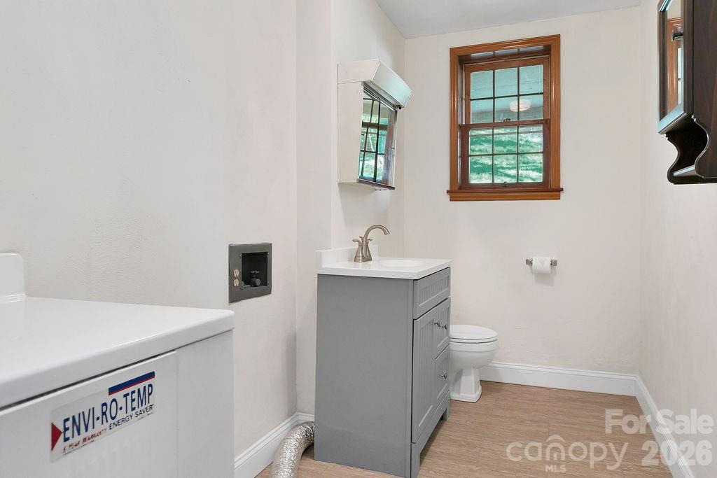1482 Island Ford Road Brevard, NC 28712 - Photo 33 of 48 a bathroom with a sink a toilet and window