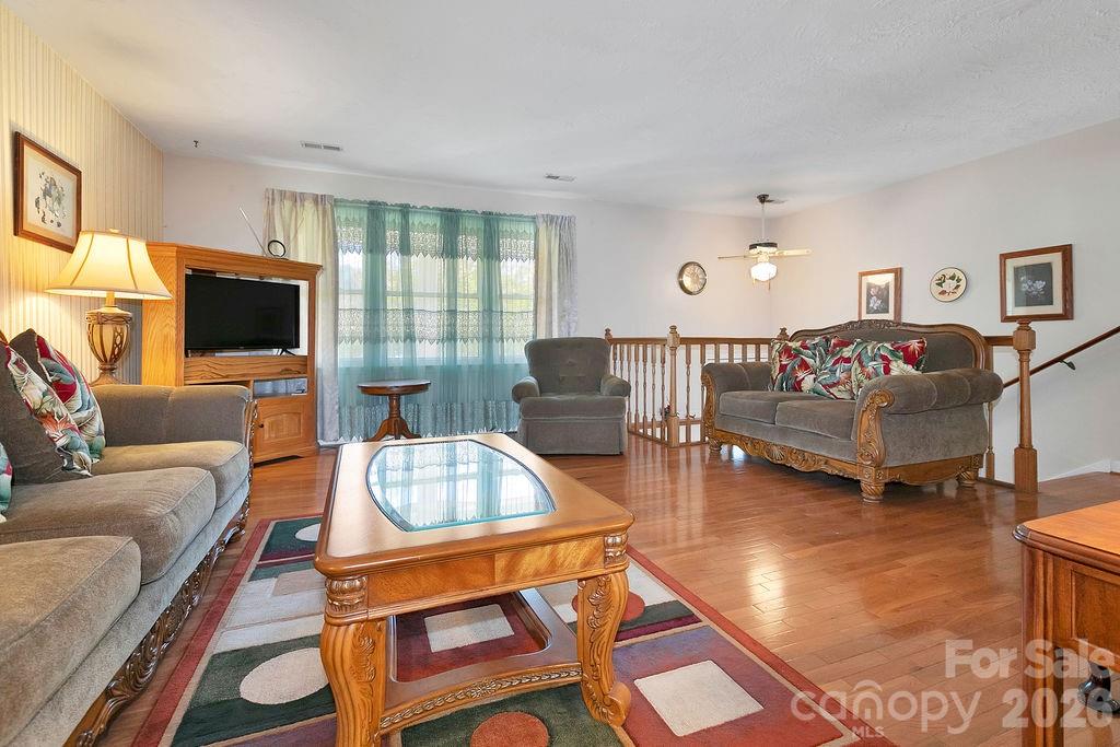 1482 Island Ford Road Brevard, NC 28712 - Photo 6 of 48 a living room with fireplace furniture and a flat screen tv