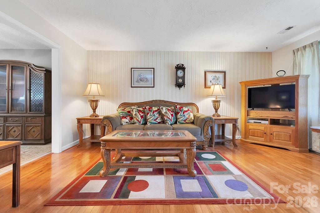 1482 Island Ford Road Brevard, NC 28712 - Photo 7 of 48 a living room with furniture a flat screen tv and a rug