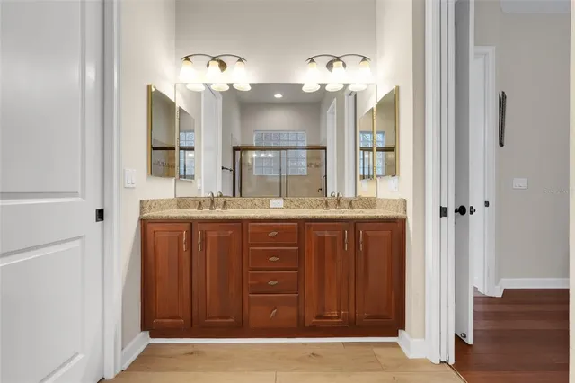 a bathroom with a double vanity sink and a mirror