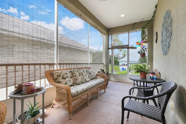 a living room with furniture and floor to ceiling window