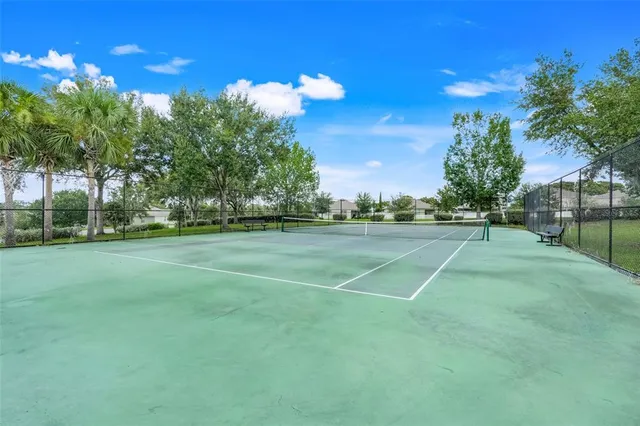 a view of a playground with basketball court