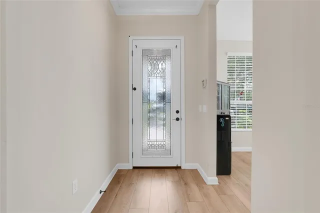 a view of a room with wooden floor and windows