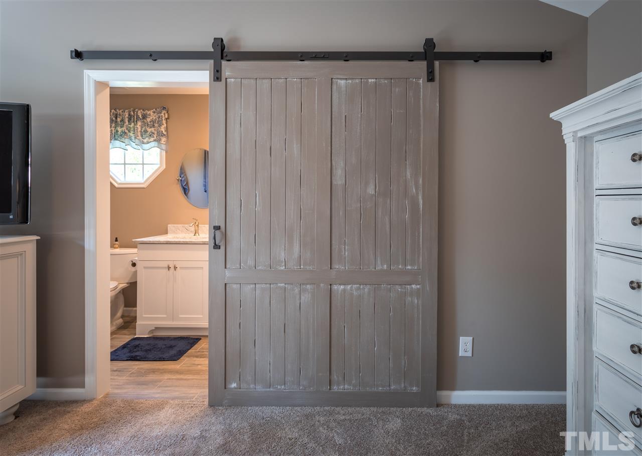 4017 Forty-Niner's Road Clayton, NC 27520 - Photo 13 of 25 Beautiful Barn Door Leads into Updated Master Bath