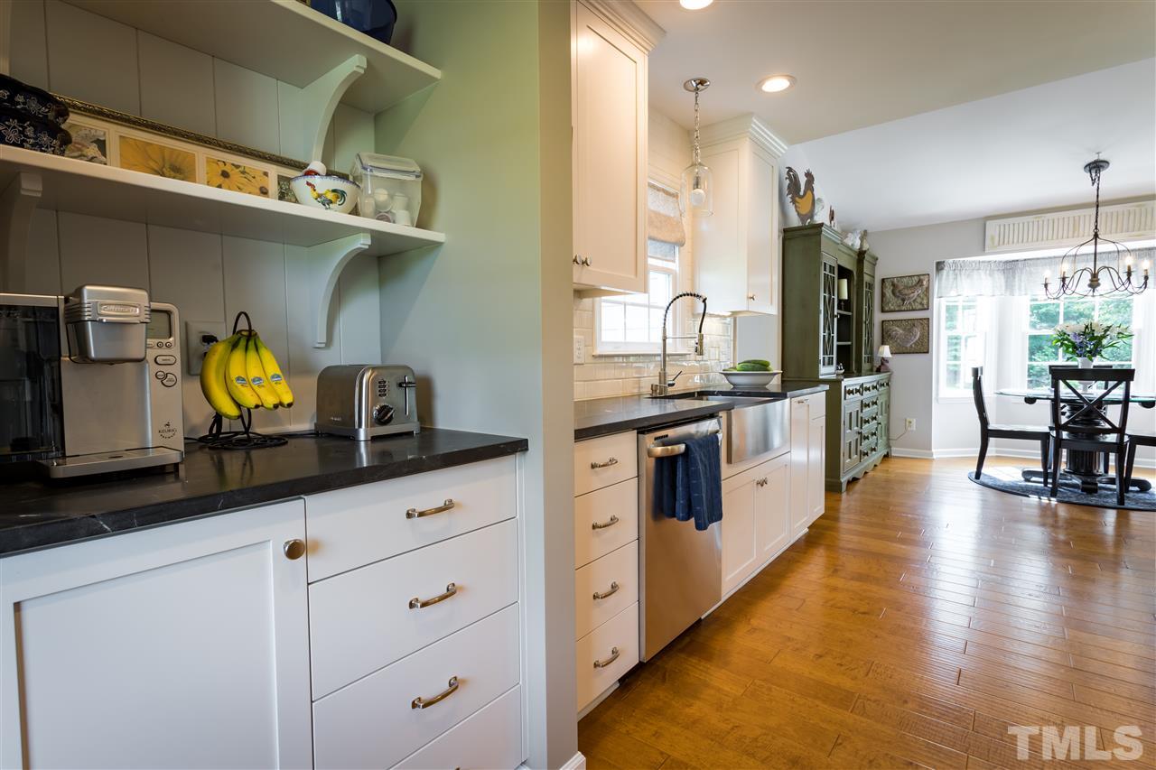 4017 Forty-Niner's Road Clayton, NC 27520 - Photo 5 of 25 Cute Open Shelving and Abundance of Cabinets and Counterspace in this Kitchen