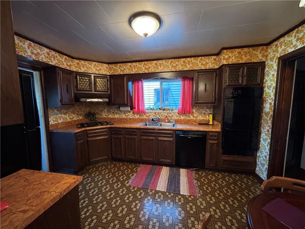 603 7th Avenue Coraopolis, PA 15108 - Photo 6 of 12 a kitchen with stainless steel appliances kitchen island granite countertop a refrigerator stove top oven and sink