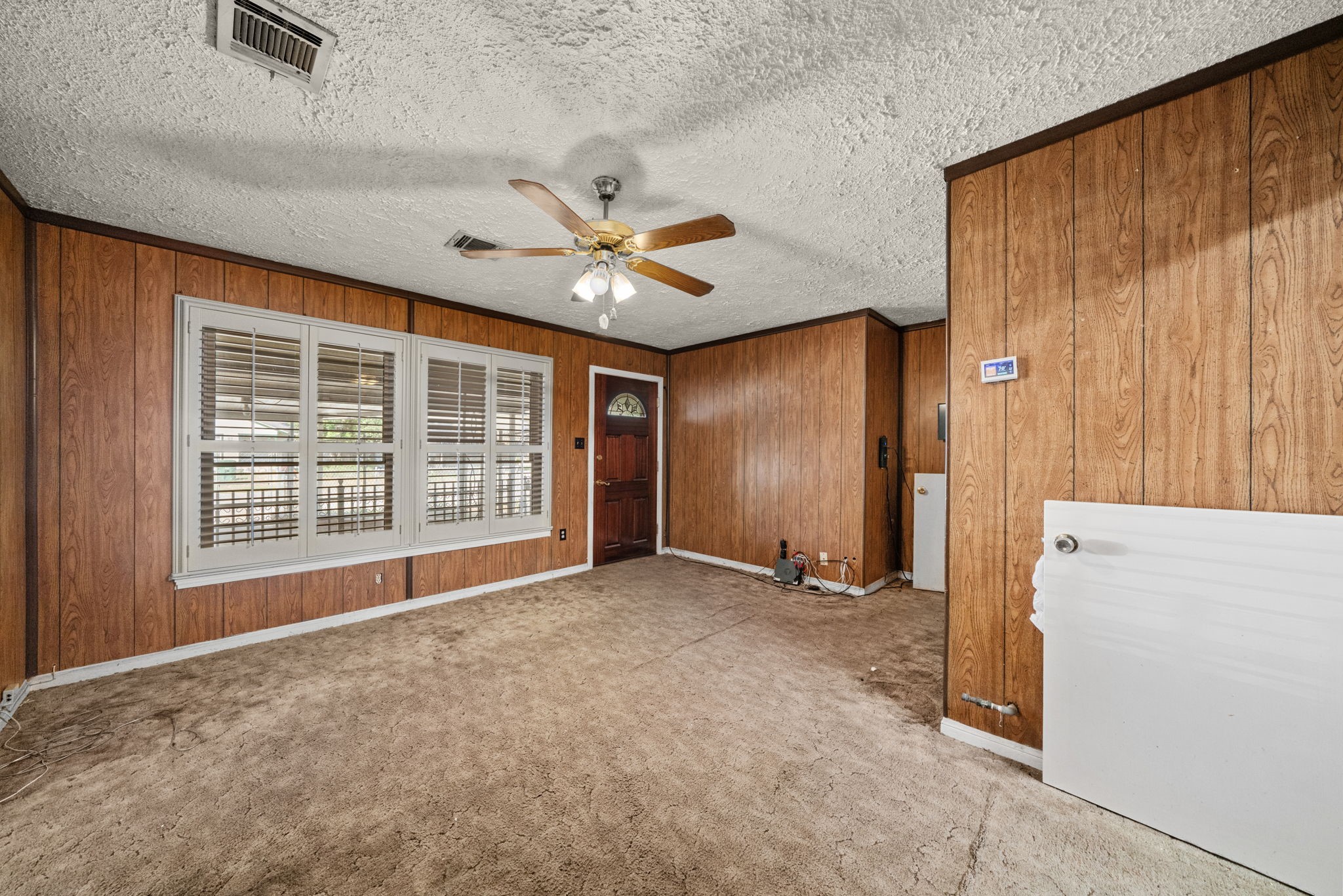 56 Wellford Street Houston, TX 77022 - Photo 5 of 26 an empty room with a ceiling fan and a window