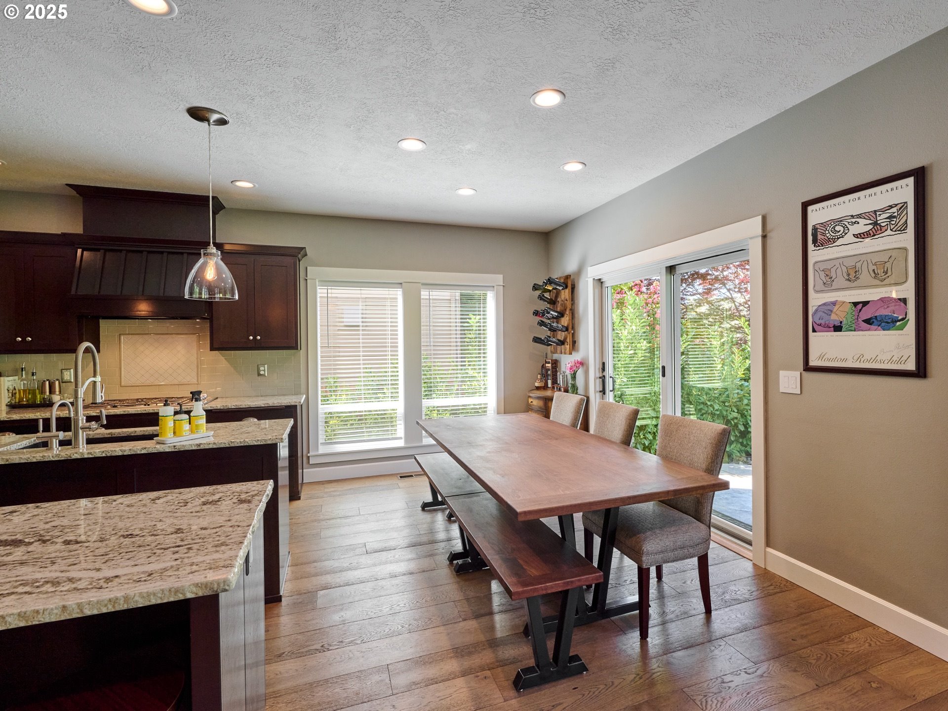3035 Elliot Street Northwest Salem, OR 97304 - Photo 12 of 46 a kitchen with a stove a refrigerator a sink dishwasher with a dining table and chairs with wooden floor