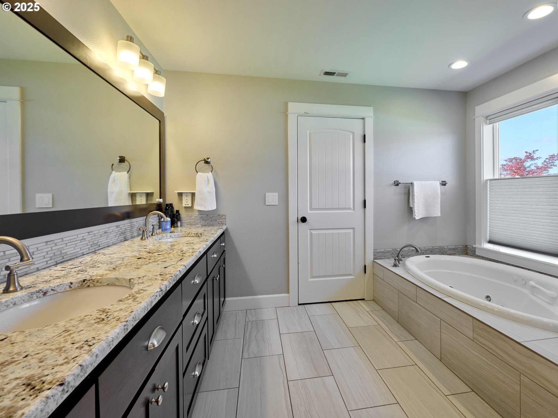 3035 Elliot Street Northwest Salem, OR 97304 - Photo 26 of 46 a spacious bathroom with a granite countertop sink a mirror and shower