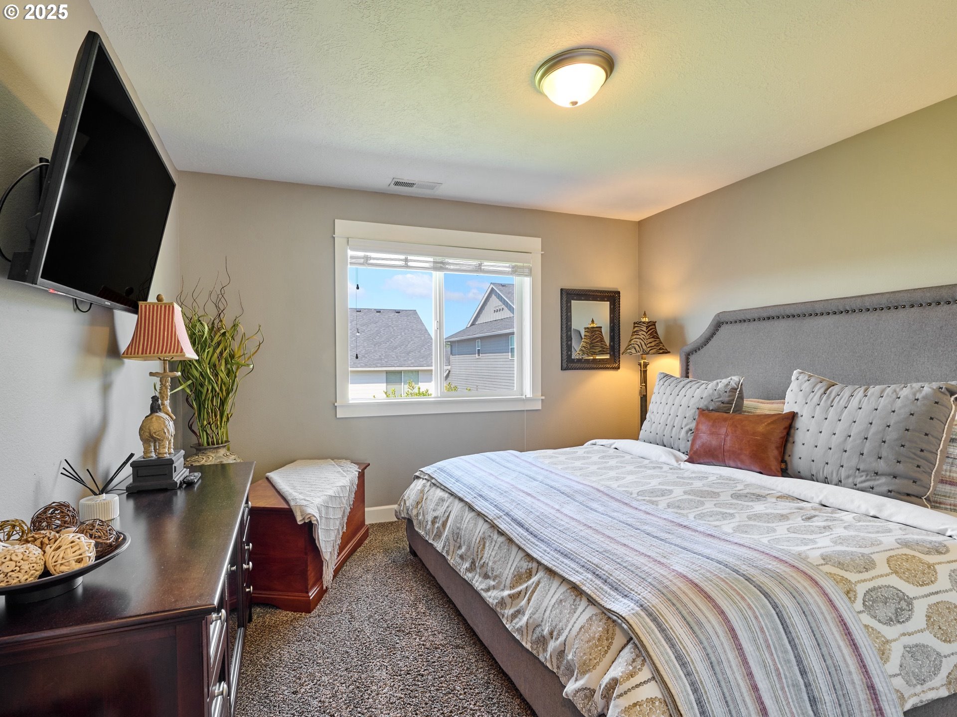 3035 Elliot Street Northwest Salem, OR 97304 - Photo 30 of 46 a bedroom with a bed flat screen tv and window