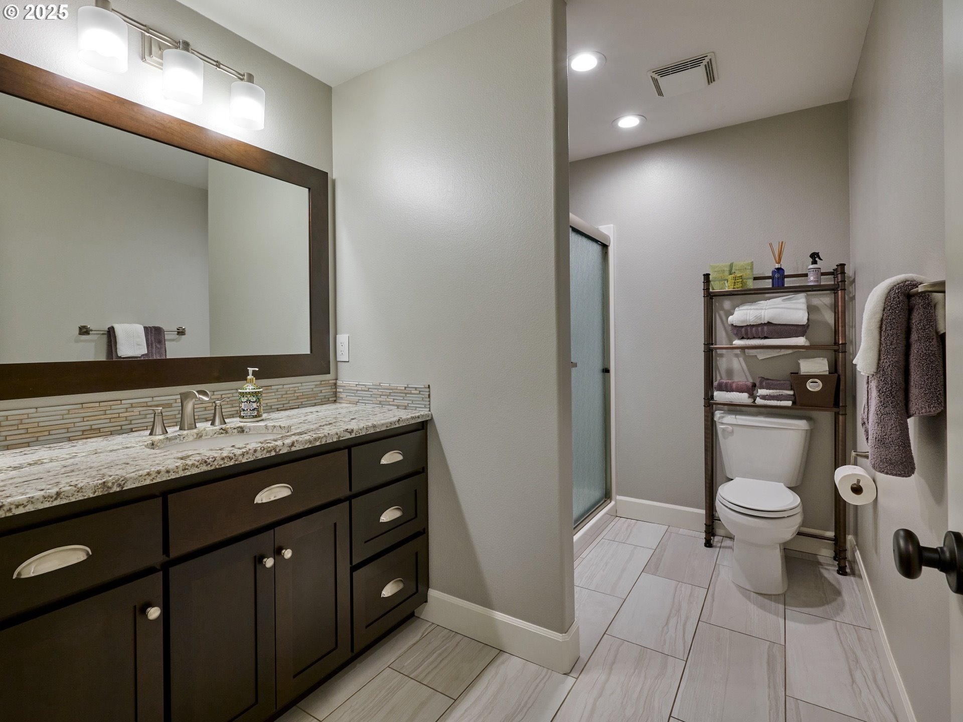 3035 Elliot Street Northwest Salem, OR 97304 - Photo 36 of 46 a bathroom with a granite countertop toilet sink and mirror