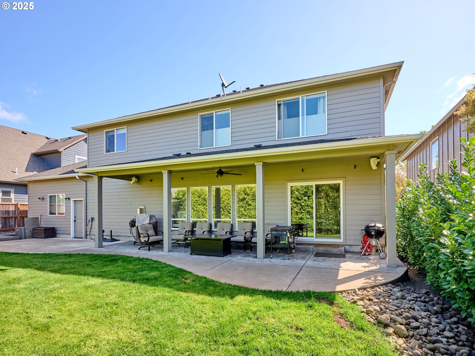 3035 Elliot Street Northwest Salem, OR 97304 - Photo 45 of 46 a view of a patio with table and chairs potted plants and large tree