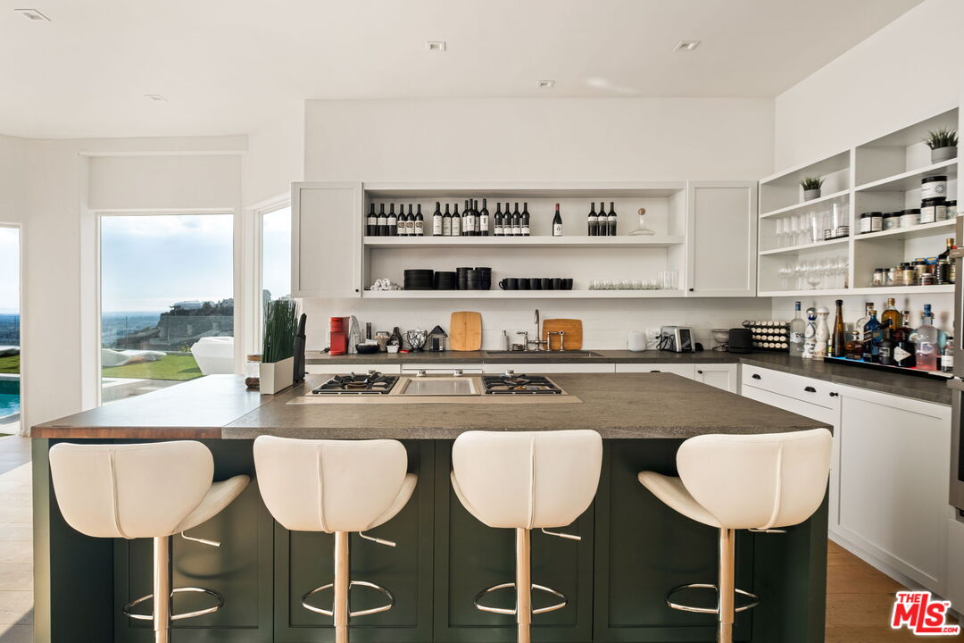 7868 Electra Drive Los Angeles, CA 90046 - Photo 14 of 42 a kitchen with a dining table chairs and view living room