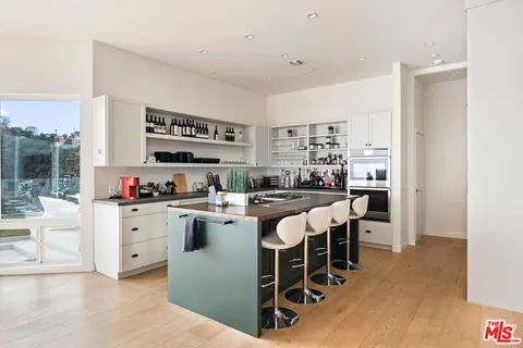 a large kitchen with a table and chairs in it