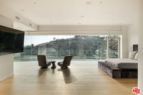 a living room with couches chairs and a flat screen tv