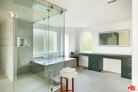a bathroom with a double vanity sink tub and a mirror