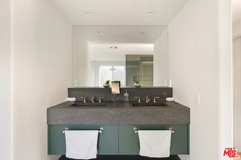 a living room with granite countertop a sink and a granite counter top