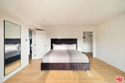 a spacious bedroom with a bed and a couch