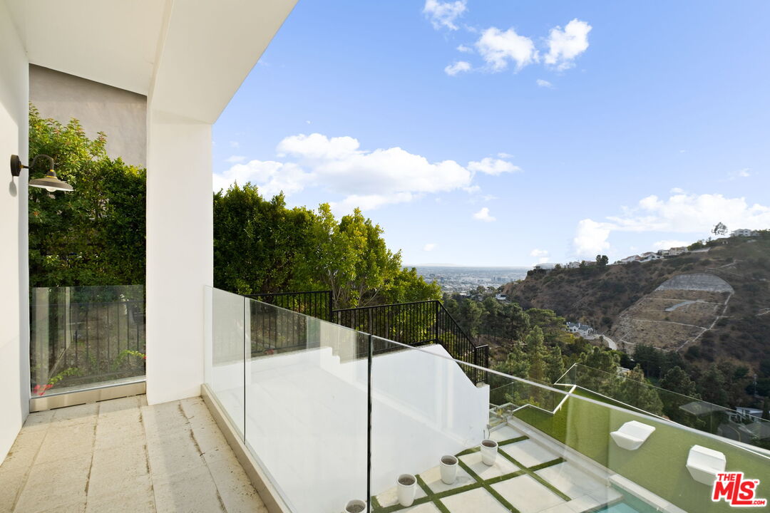7868 Electra Drive Los Angeles, CA 90046 - Photo 30 of 42 a view of a balcony with a floor to ceiling window and potted plants